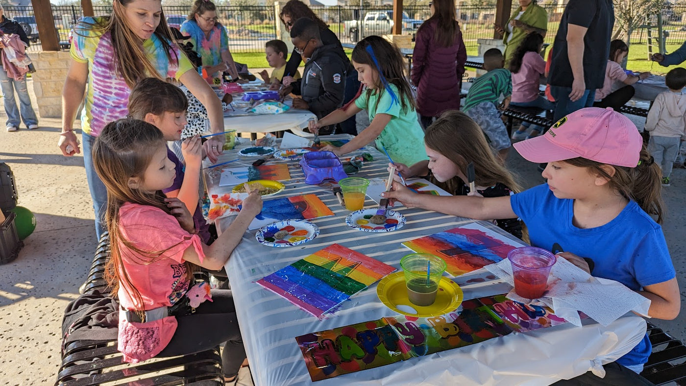 Kids creating colorful paintings at SIS paint party