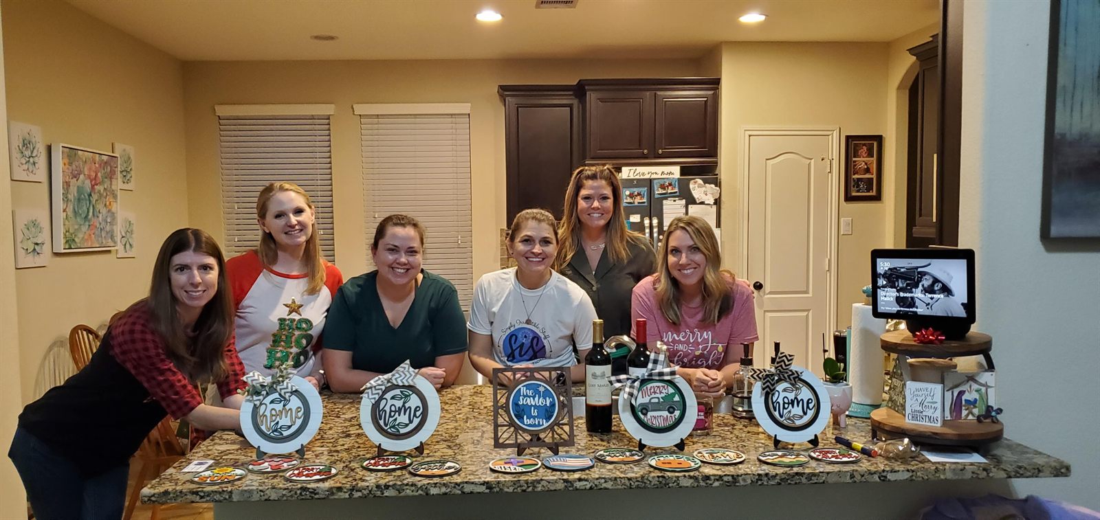 Paint party group smiling with finished holiday projects