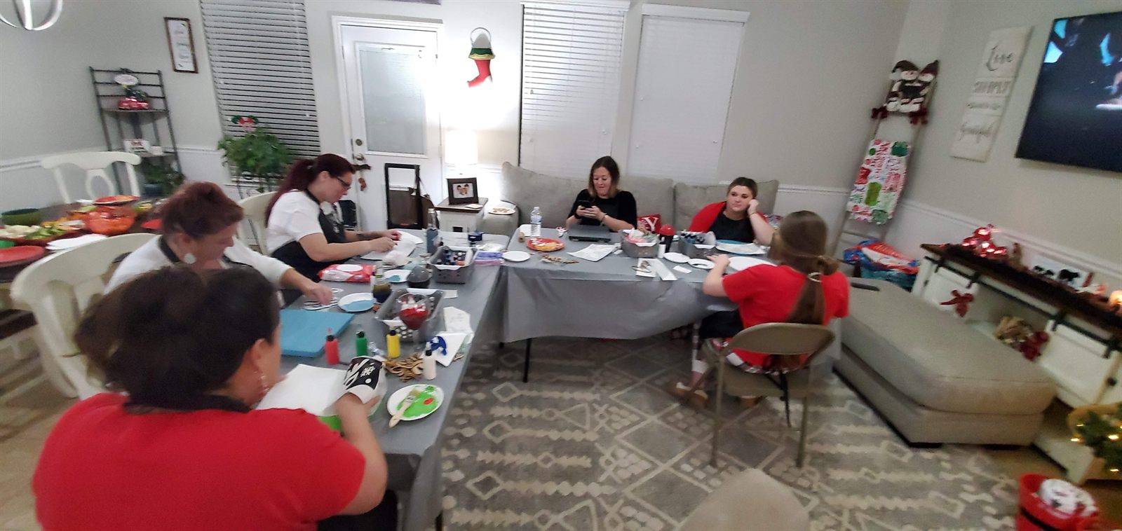Guests painting at a holiday paint party